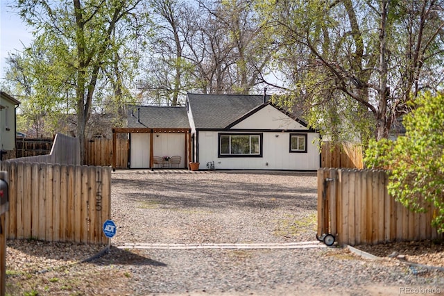 1755 Ingalls St, Lakewood, CO 80214 - view of front facade featuring a shingled roof, driveway, and a gate