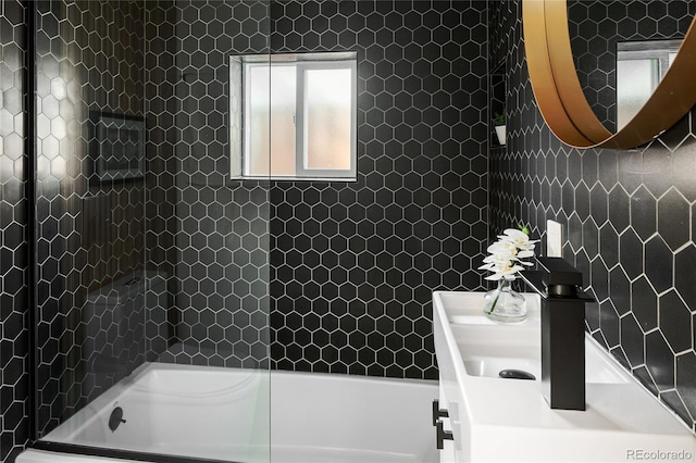 1755 Ingalls St, Lakewood, CO 80214 - full bathroom featuring tile walls, shower / bath combination, and vanity