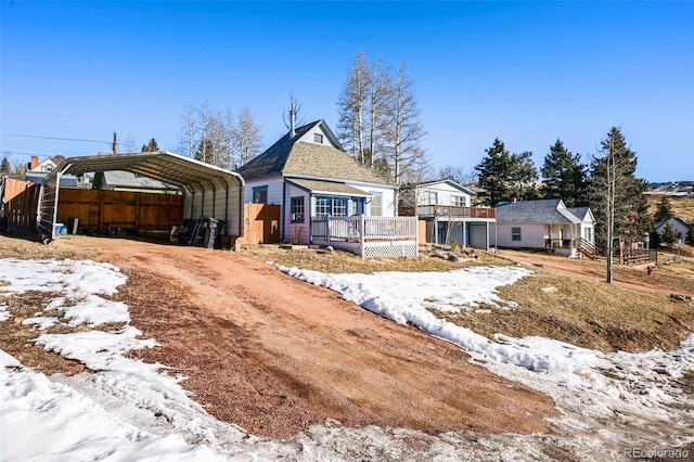 view of front of house with a deck and a carport