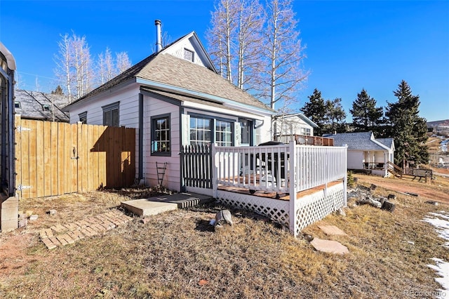 rear view of property with a wooden deck