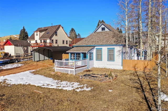 view of front of home featuring a carport and a wooden deck