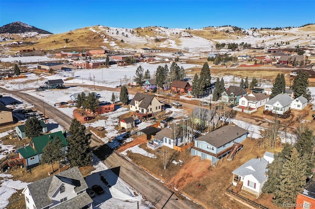 snowy aerial view featuring a mountain view