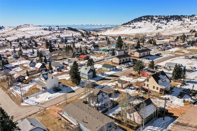 snowy aerial view featuring a mountain view