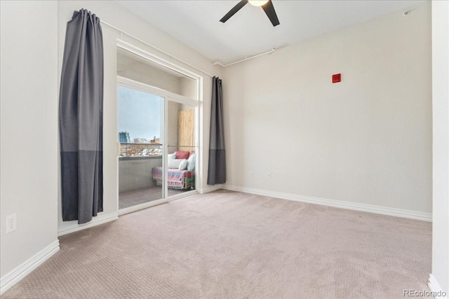 interior space with carpet floors, baseboards, and a ceiling fan