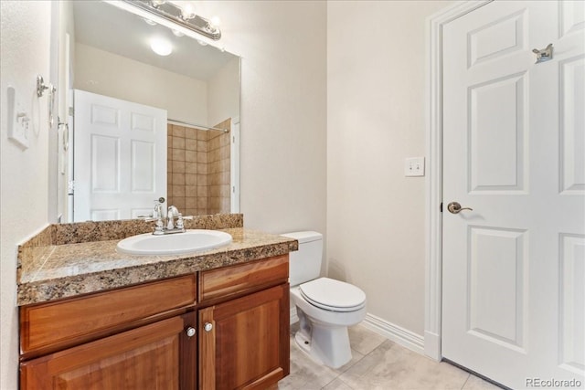 bathroom featuring toilet, vanity, baseboards, a shower, and tile patterned floors