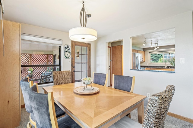 dining space featuring baseboards