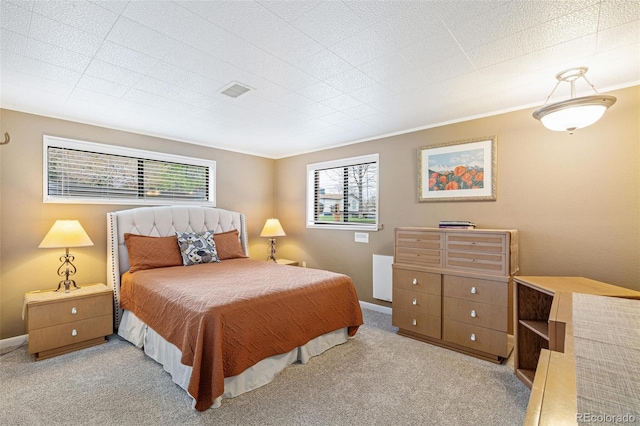 bedroom featuring carpet flooring, crown molding, and baseboards