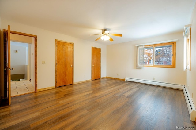 unfurnished room with hardwood / wood-style floors, baseboard heating, and ceiling fan