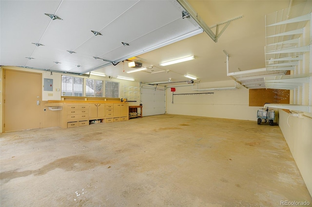 garage with electric panel and a garage door opener