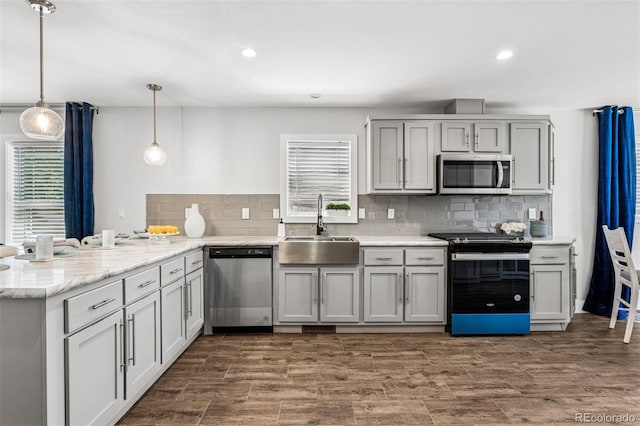 5202 Reed St, Arvada, CO 80002 - kitchen featuring stainless steel appliances, a sink, healthy amount of natural light, a peninsula, and recessed lighting