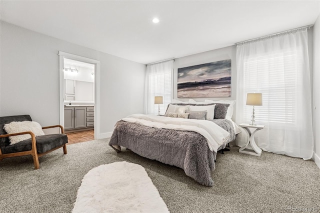 5202 Reed St, Arvada, CO 80002 - bedroom featuring light carpet, a sink, baseboards, connected bathroom, and recessed lighting