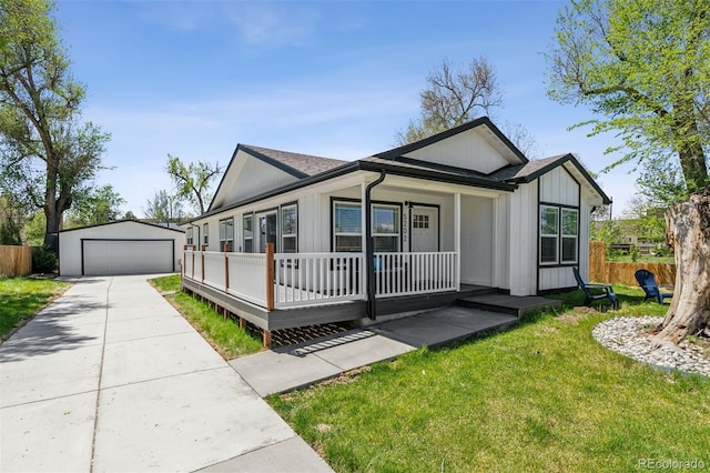 5202 Reed St, Arvada, CO 80002 - view of front facade with a detached garage, an outdoor structure, a porch, and board and batten siding
