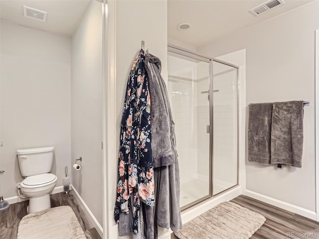 5995 Fencerow Pl, Brighton, CO 80601 - full bath featuring wood finished floors, toilet, a shower stall, and baseboards