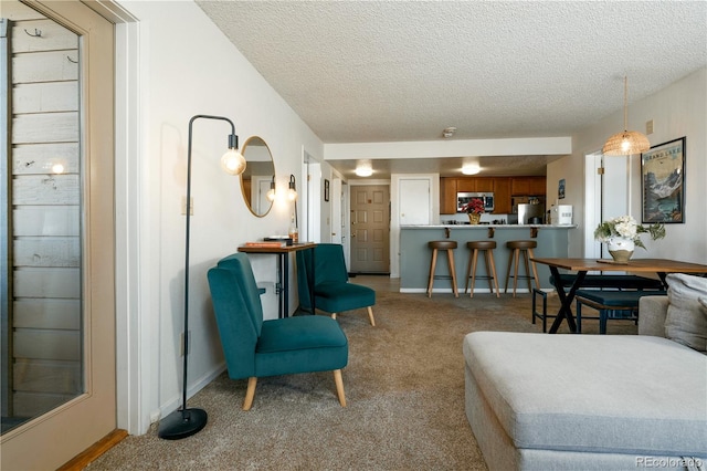 living room featuring light colored carpet and a textured ceiling