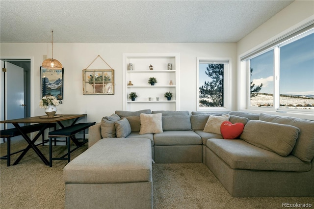 carpeted living room featuring built in features and a textured ceiling