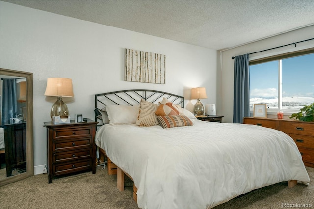 bedroom with light colored carpet and a textured ceiling