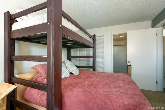 bedroom featuring carpet flooring and a textured ceiling