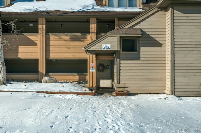 view of snow covered property entrance