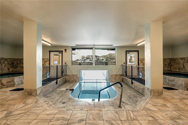 view of pool with an indoor in ground hot tub