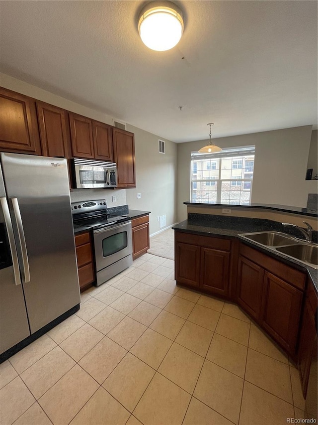 17346 Nature Walk Trl Unit 201, Parker, CO 80134 - kitchen featuring stainless steel appliances, a sink, dark countertops, and light tile patterned floors