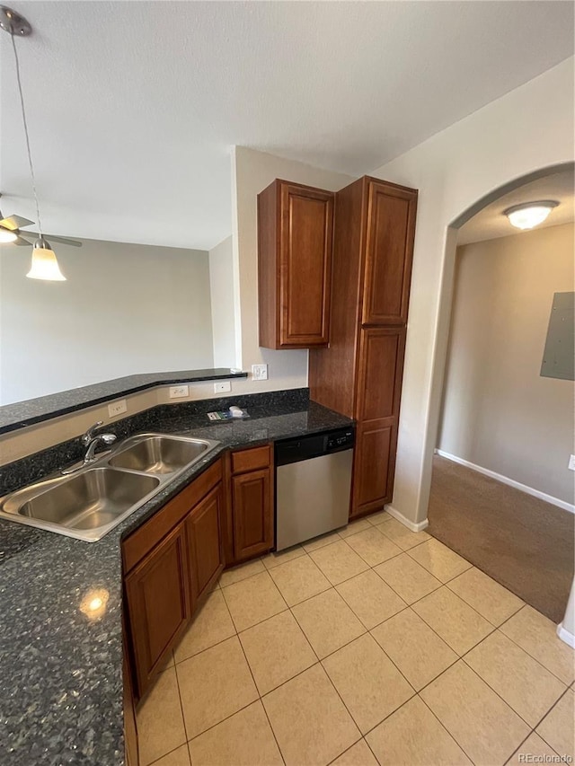 17346 Nature Walk Trl Unit 201, Parker, CO 80134 - kitchen with dishwasher, a sink, arched walkways, light tile patterned floors, and brown cabinets