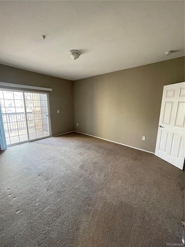 17346 Nature Walk Trl Unit 201, Parker, CO 80134 - empty room featuring carpet flooring, baseboards, a smoke detector, and a pendent fire sprinkler