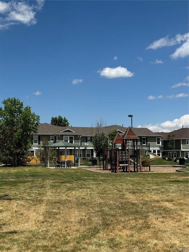 17346 Nature Walk Trl Unit 201, Parker, CO 80134 - rear view of property featuring a playground and a lawn