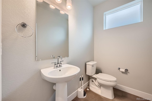 bathroom featuring hardwood / wood-style floors and toilet