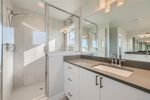 bathroom with walk in shower and vanity