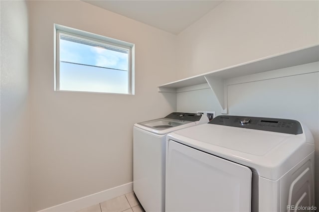 washroom featuring light tile patterned flooring and washing machine and dryer