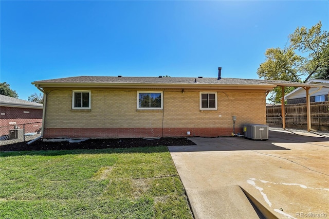 back of house with a patio area, a yard, and central AC