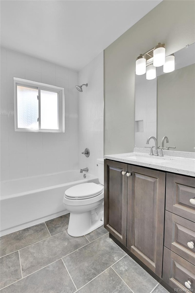 full bathroom featuring vanity, toilet, and tiled shower / bath