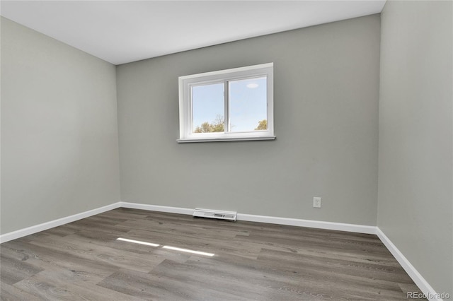 unfurnished room featuring hardwood / wood-style flooring