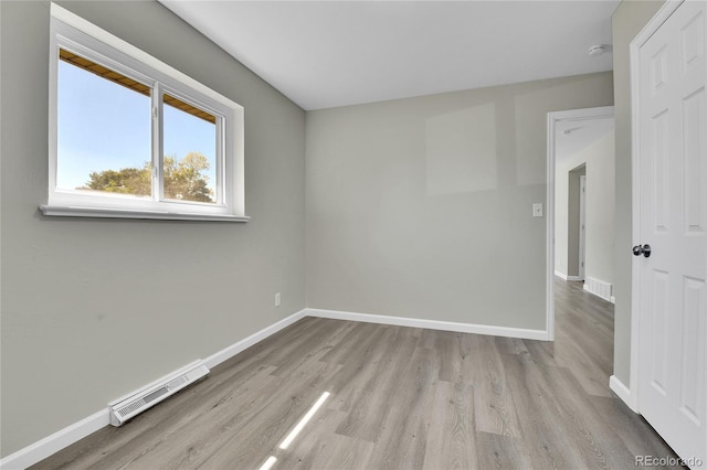 empty room with light hardwood / wood-style flooring