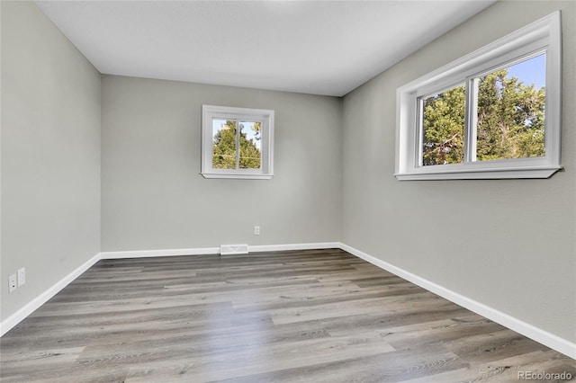 empty room with light hardwood / wood-style floors