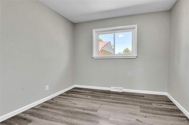 unfurnished room featuring wood-type flooring