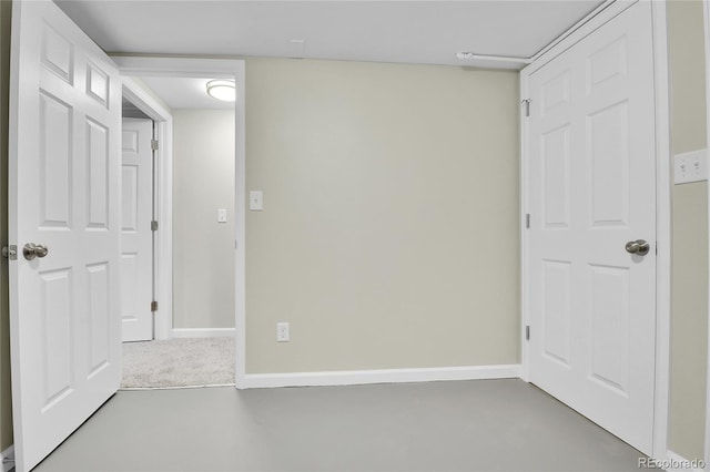 unfurnished bedroom with concrete floors