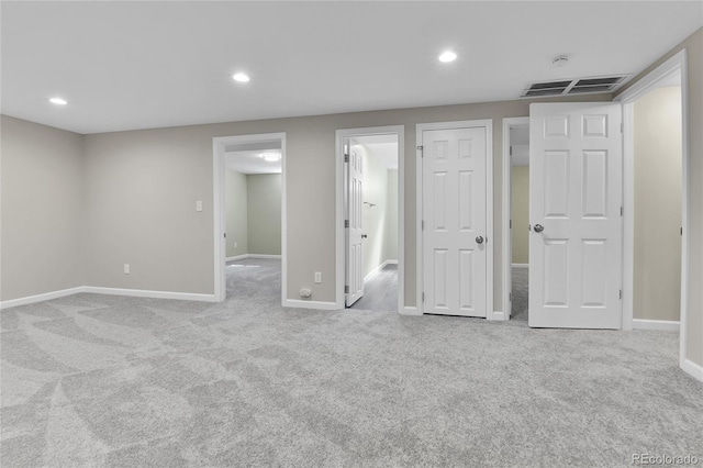 interior space featuring ensuite bath and light carpet