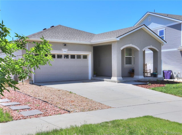 20194 Robins Dr, Denver, CO 80249 - view of front of property with driveway, an attached garage, covered porch, stucco siding, and roof with shingles