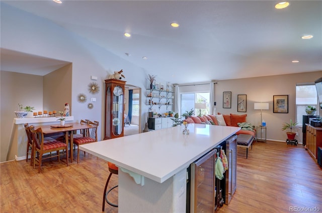 20194 Robins Dr, Denver, CO 80249 - kitchen featuring light wood-style floors, wine cooler, a center island, recessed lighting, and baseboards