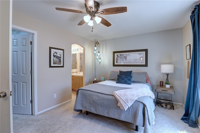 20194 Robins Dr, Denver, CO 80249 - bedroom with carpet flooring, arched walkways, baseboards, and connected bathroom
