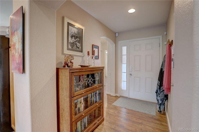 20194 Robins Dr, Denver, CO 80249 - entrance foyer with arched walkways, light wood-style flooring, and baseboards