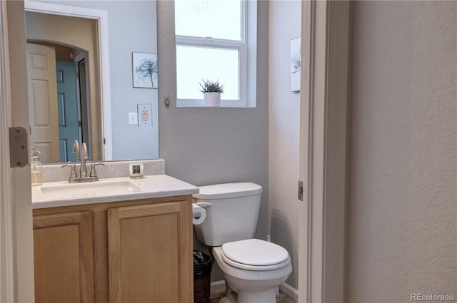 20194 Robins Dr, Denver, CO 80249 - half bath featuring a textured wall, vanity, and toilet