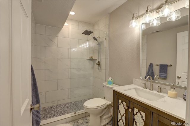 20194 Robins Dr, Denver, CO 80249 - bathroom featuring toilet, vanity, walk in shower, and a textured wall