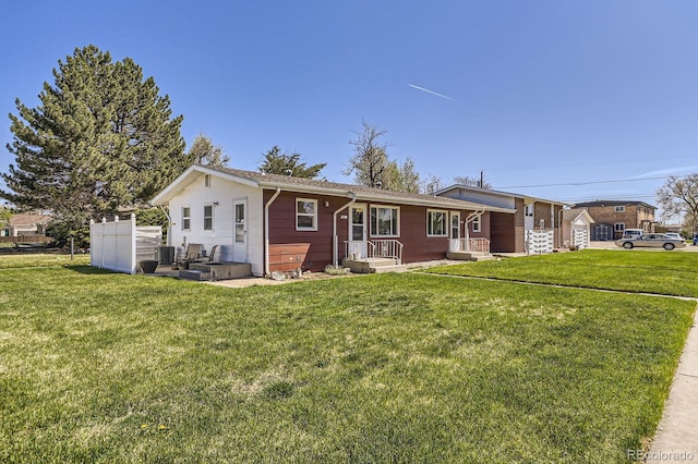single story home featuring cooling unit and a front yard