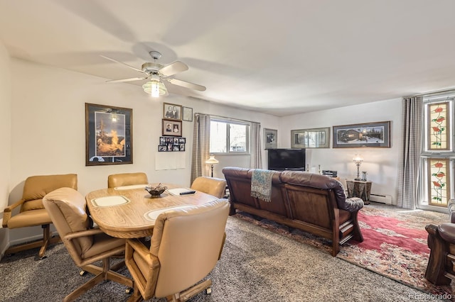 dining area featuring carpet flooring, ceiling fan, and a baseboard heating unit