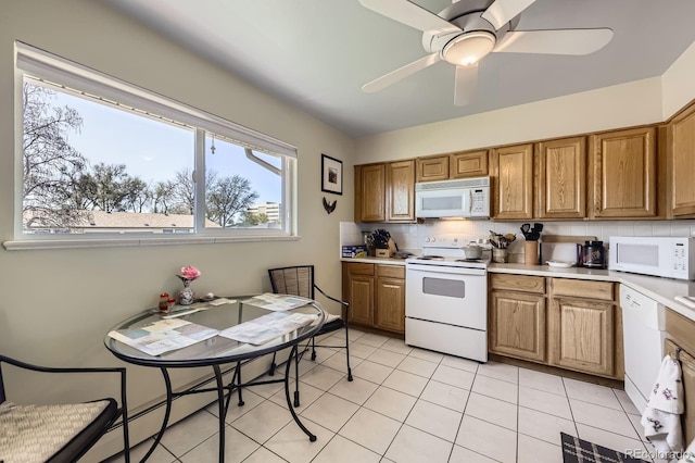kitchen with white appliances, brown cabinets, backsplash, and light countertops