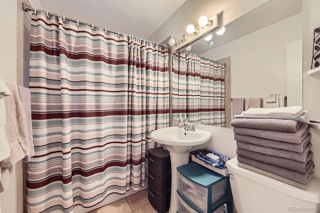 full bath featuring curtained shower and tile patterned flooring