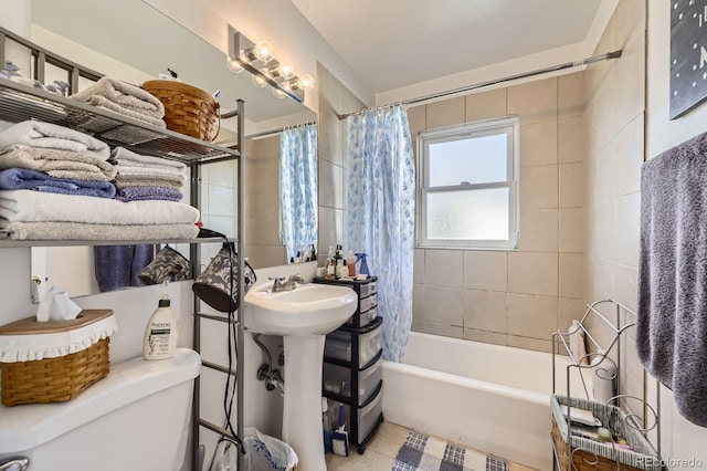 full bath featuring tile patterned floors, shower / bath combination with curtain, and toilet