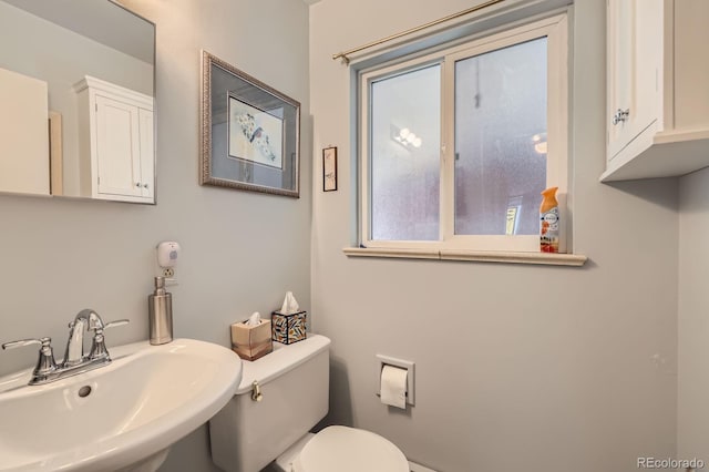 half bath with toilet and a sink